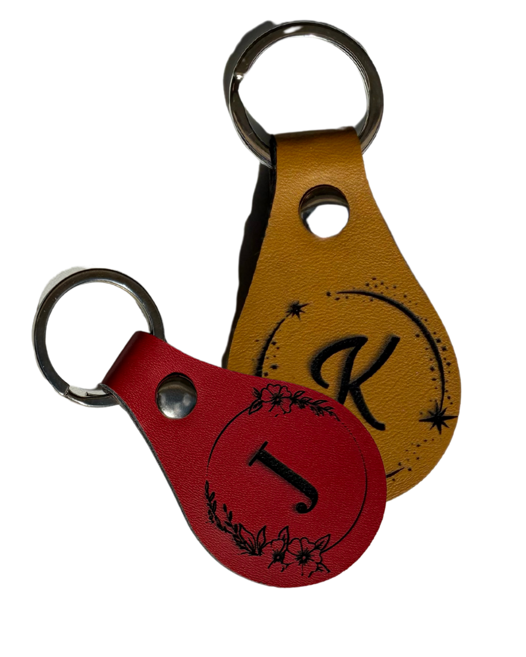 Two leather keychains with letter 'K' design on a white background