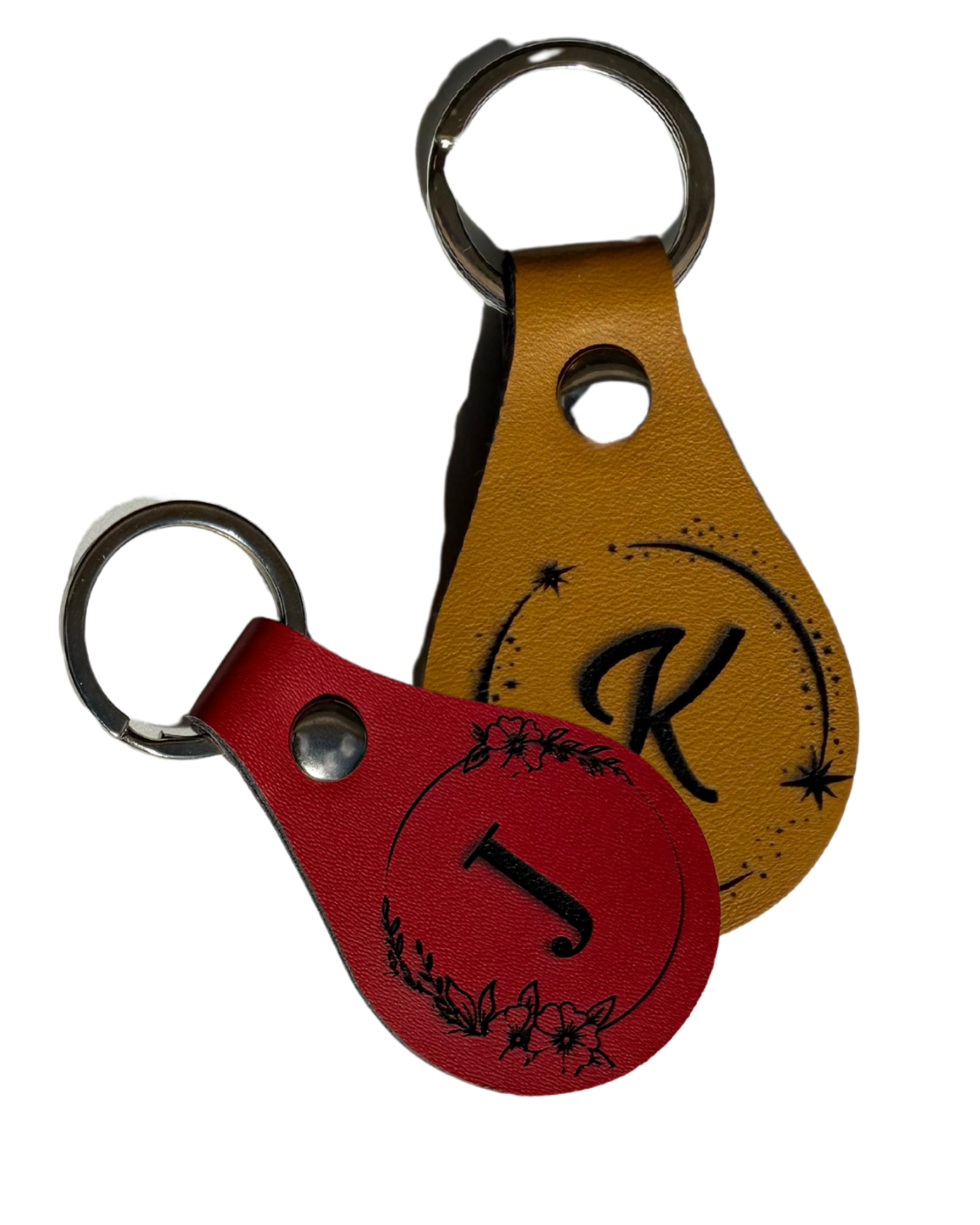 Two leather keychains with letter 'K' design on a white background